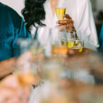 Indian bride toasting on her wedding with bridesmaids styled by Pattupleats